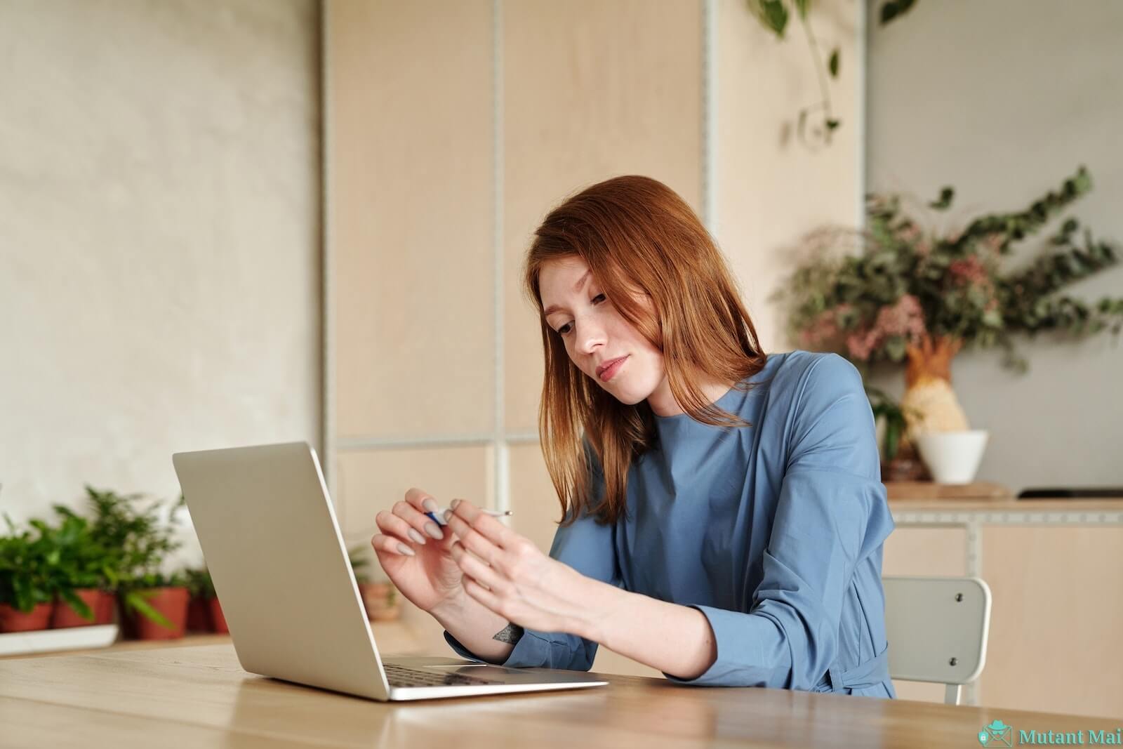 Woman in Blue Long Sleeve Shirt Using Macbook Air