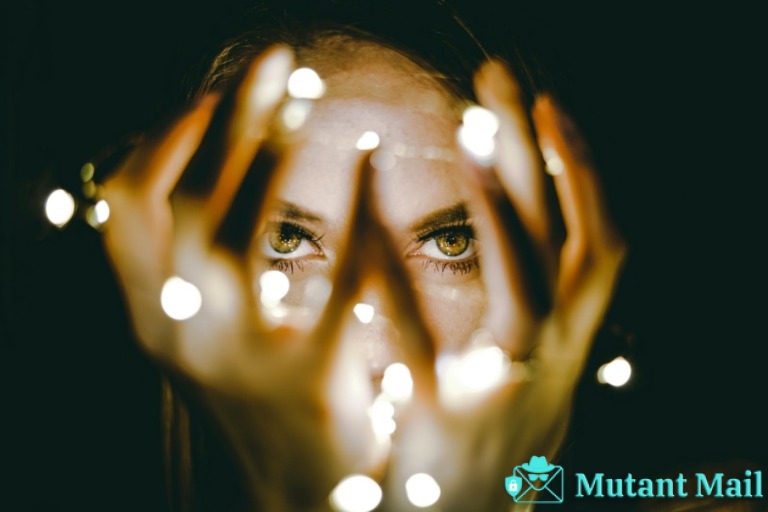 woman holding string lights